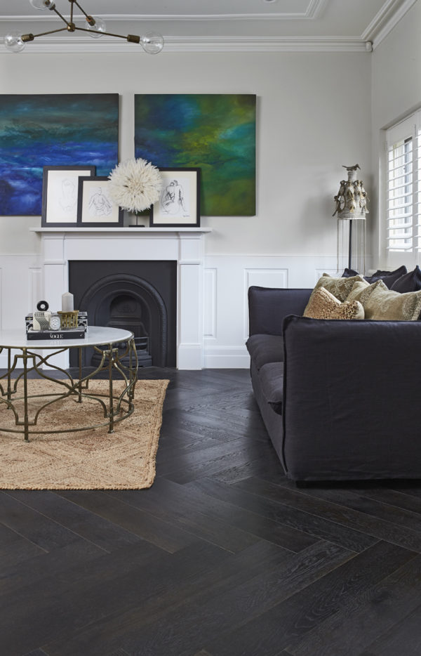 Modern interior featuring dark herringbone wood flooring.