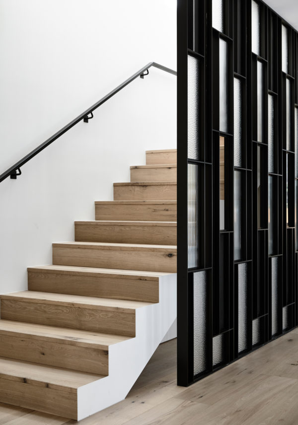 Minimalist interior featuring white-stained wood flooring.